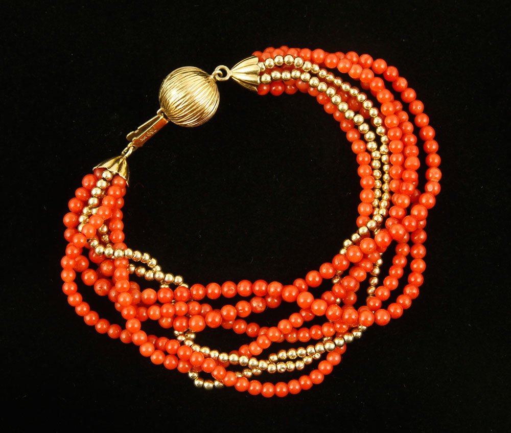 18K Gold and Coral Bracelet: Beaded bracelet, coral with 18K gold clasp and beads, marked 750, 8" l. Provenance: From a California estate.