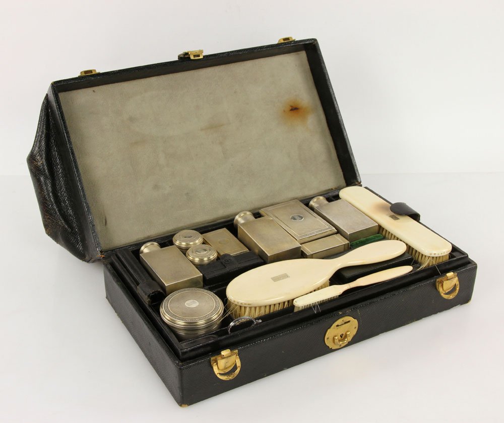 French Silver Traveling Dresser Set: French traveling dresser set, silver, with plastic trim, marked G. Keller Paris, hallmarked with Minerva head symbol, approx. 25.8 troy oz. total weight, 10" h x 14" w x 8" d. Includes leather case. P