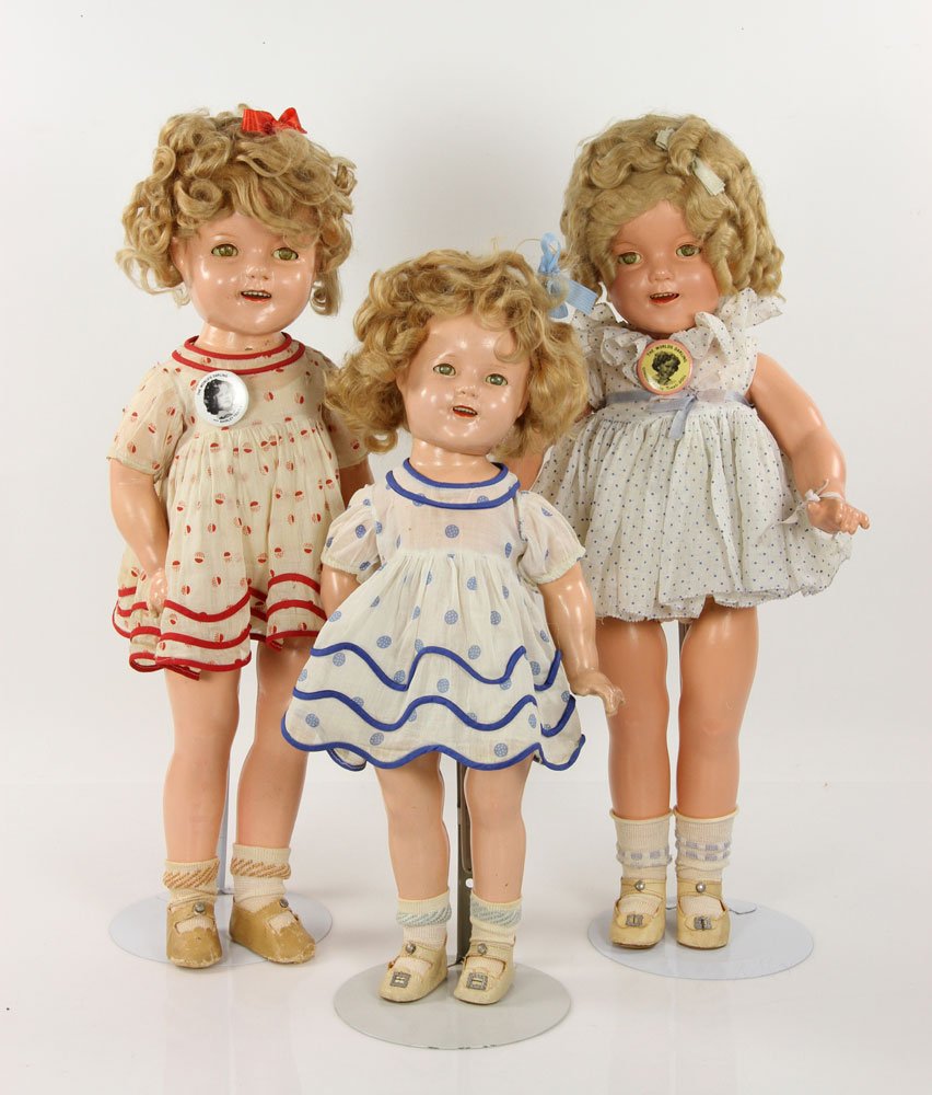 Lot of Three Shirley Temple Dolls: 3 Shirley Temple dolls made by Ideal in 1934 with polka-dot dresses and pins, 2 large dolls 22" h, 1 medium doll 18" h. Provenance: From a Massachusetts estate.