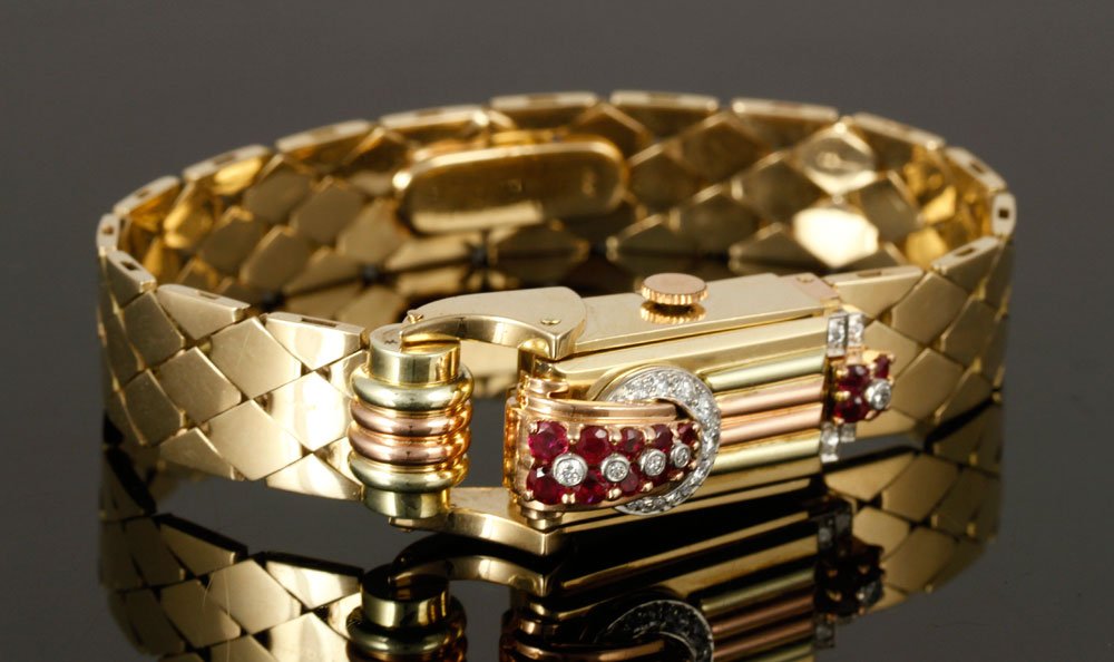 14K Gold, Diamond and Ruby Watch: Ladies' watch, 14k tricolor gold, with diamonds and rubies, 7" l, approx. 54g total weight. Provenance: from a New York collection.