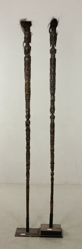 Pair of Carved Totems: Pair of carved totems, wood, with hair decoration, Indonesia, 70" h x 2.5" w (both). Provenance: acquired in 1960's from the Indonesian island of Nias, from a California estate.