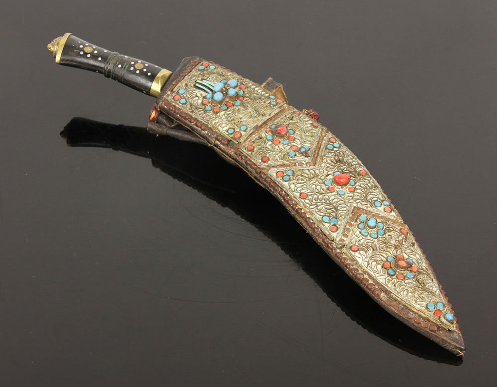 Afghan Kukri: Afghan kukri, silver and brass inlay on hilt, Nepali scabbard covered in silver, coral and turquoise; 9" l (blade), 13" l (overall). Provenance: From the unreserved Vincent J. Vabri Edged Weapon Colle