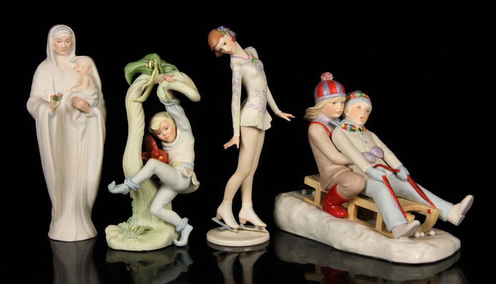 Cybis, Lot of 4 Figures: Lot of four Cybis figures, porcelain, to include: figure of children sledding, ice skater, Madonna with child and boy with chicken; tallest 9 1/2" h. Provenance: From a New Hampshire estate.