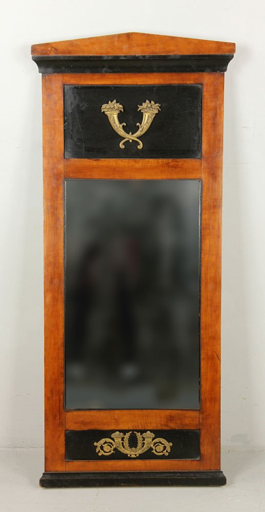 French Empire Pier Mirror: French Empire bronze mounted and partially ebonized pier mirror, of architectural form, embellished with gilded bronze fruit filled cornucopias and scrolling acanthus; 21 3/4" h x 12 3/4" w (view), 43