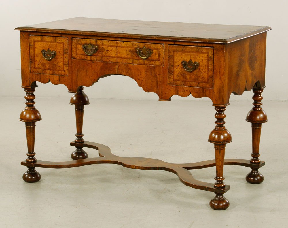 William and Mary Lowboy: William and Mary lowboy, veneered walnut, having three drawers, 29" h x 42" w x 21" d.