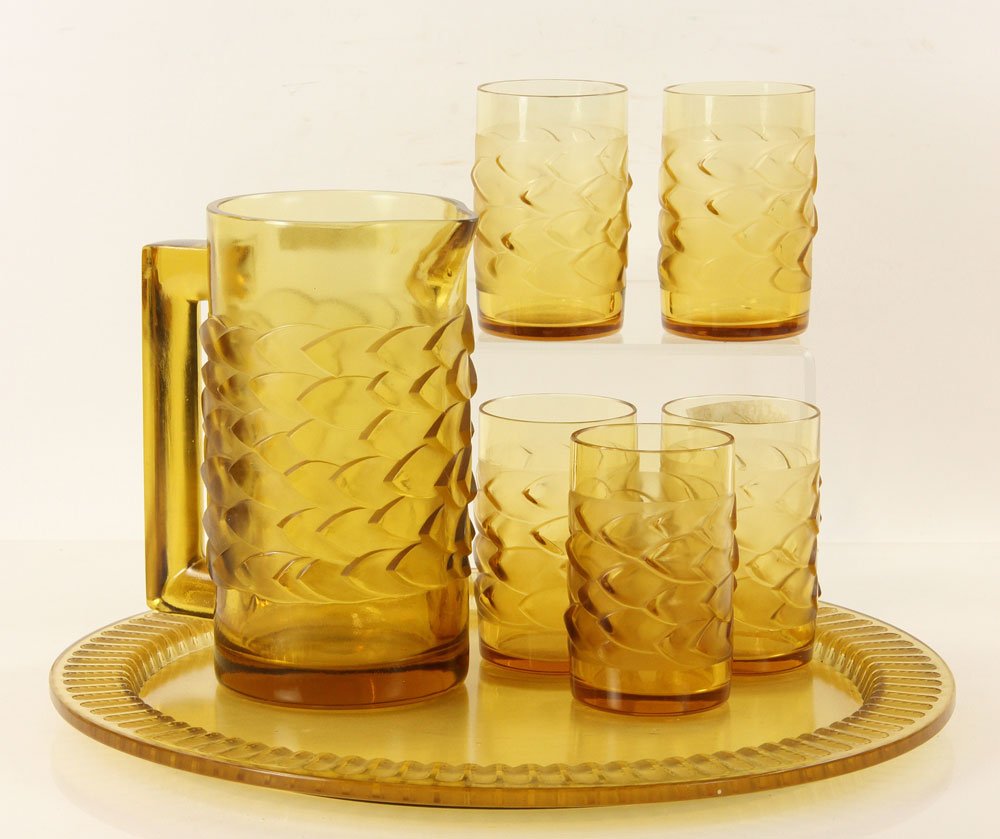 7 Lalique Items: Lot of seven R. Lalique glass items, signed, to include: pitcher, 9" h x 7 1/4" dia; tray, 16 1/4" dia; and five glasses, 4 3/4" h.
