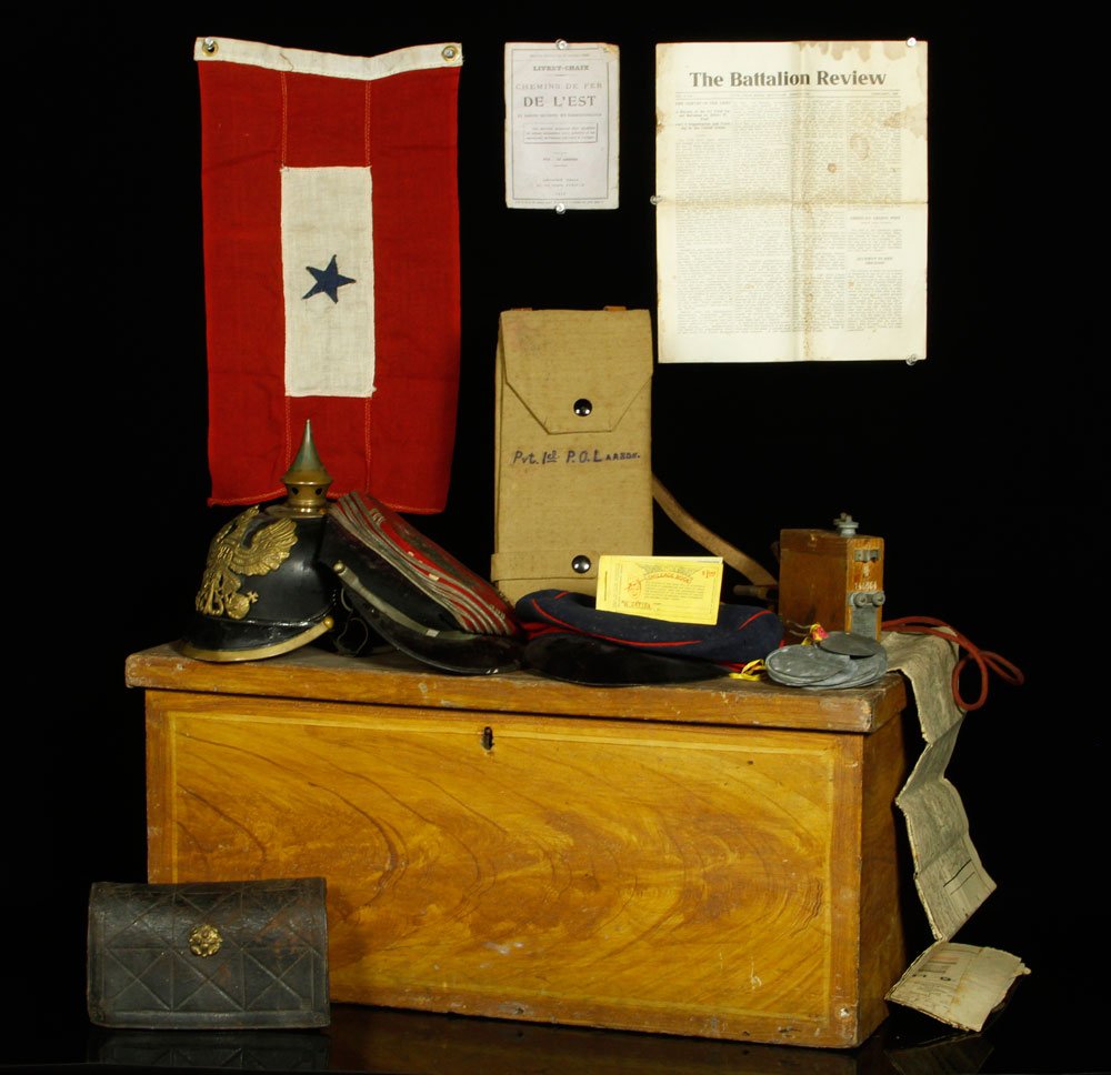 Lot of World War I Vintage Military Items: Lot of World War I vintage military items, to include: approximately 30 German name tags, bottom of gold shell case, map belt, leather ammunition belt, German electrical device, one star flag, three h