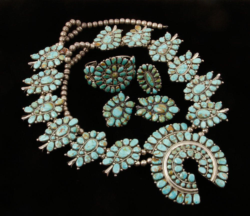 Lot of Silver and Turquoise Jewelry: Lot of jewelry, silver and turquoise, to include: sterling silver squash blossom necklace, signed "JW" for Juliana Williams, 34" l; and unsigned silver bracelet, ring and earrings; Naja measures 4" h 