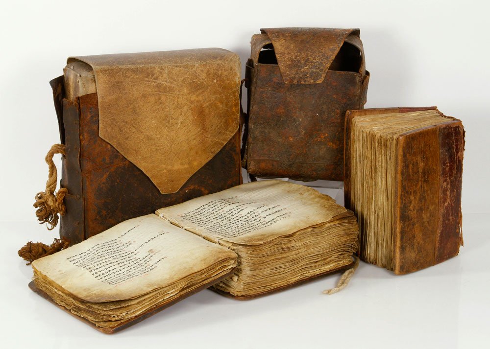 Two 15th C. Ethiopian Bibles or Prayer Books: Lot of two Ethiopian bibles or prayer books, 15th century, handwritten, with hand-crafted wooden covers and leather cases, 9" sq (largest); Amharic bibles were sold to antique dealers in Nairobi, Keny