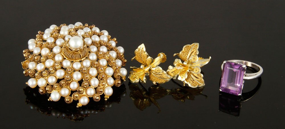 Lot of 14K Gold Jewelry: Lot of 14K gold jewelry, to include: amethyst and white gold ring, size 6 1/2; pair of yellow gold screwback earrings; and yellow gold and pearl brooch, 2" dia; approximately 34 grams TW. Provenance: