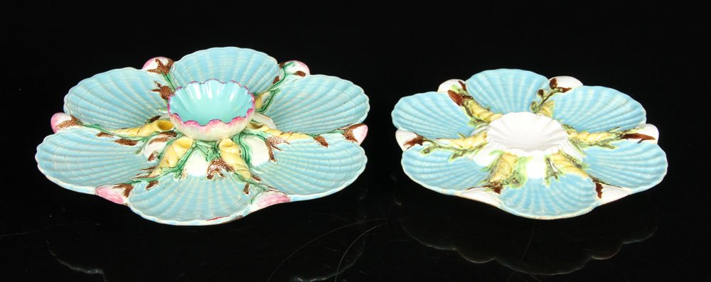 2 George Jones English Majolica Oyster Plates: Lot of two George Jones majolica plates, English, 19th century, decorated with blue shells and yellow and brown trim, each with central well, 8 3/4" dia and 10 1/2" dia. Provenance: From a California 