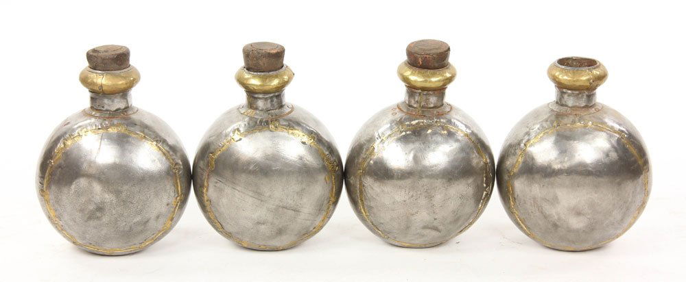 4 Decorative Metal Flasks: Lot of four decorative flasks, metal, with wood stoppers, 11 1/2" h (excluding stoppers). Provenance: From the collection of interior designer Thomas Britt.