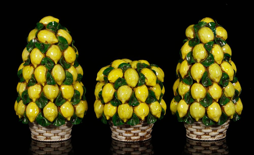 Trio of Terra Cotta Lemon Bunches: Trio of lemon bunches, terra cotta, two large and one medium, largest 17 1/2" h x 11" dia. Provenance: From the collection of interior designer Thomas Britt.
