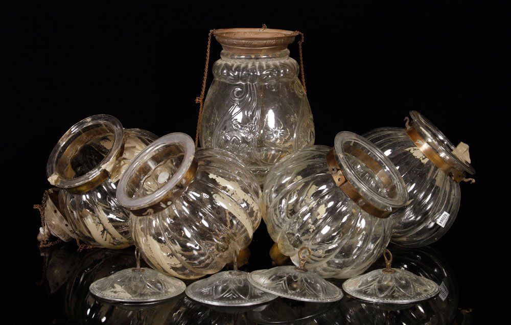 5 Hanging Chandeliers: Set of five round hanging chandeliers, glass with brass fittings, 10 1/2" h x 9" dia. Provenance: From the collection of interior designer Thomas Britt.