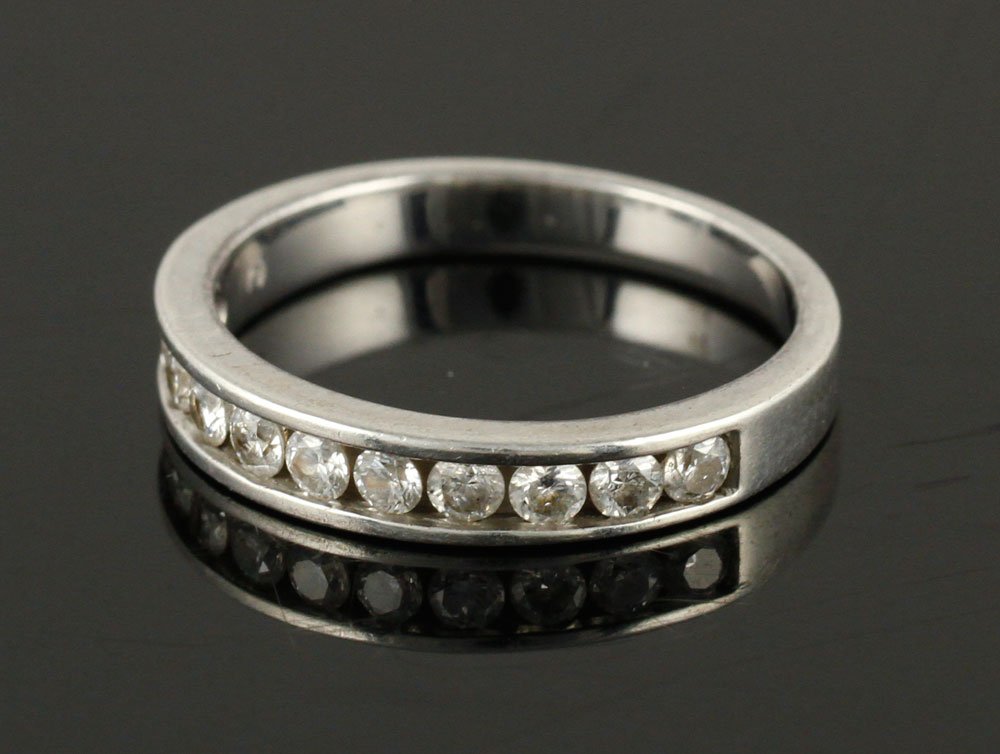 Diamond and Platinum Wedding Ring: Diamond and platinum wedding ring, with eleven stones totaling approximately 1 carat, size 7. Provenance: From a Massachusetts estate.