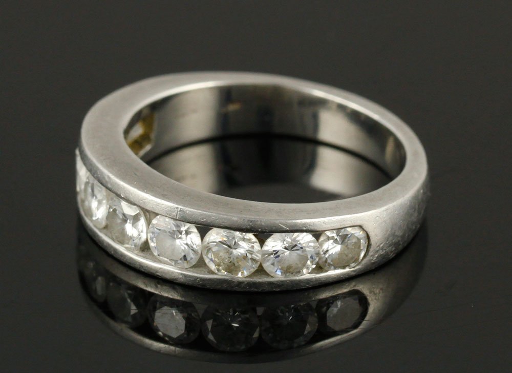 Platinum and Diamond Wedding Ring: Ladies' platinum and diamond wedding ring, nine diamonds with largest approximately .25 carats, size 7. Provenance: From a Massachusetts estate.