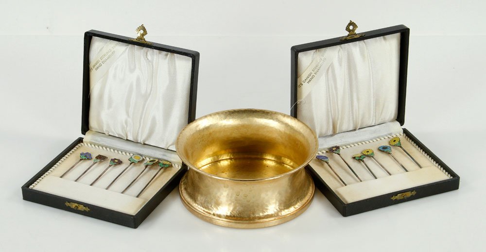 Lot of Silver Items: Lot of silver items, to include: Pampaloni wine coaster, sterling silver with gold wash, marked "925" on base, 2" h x 5" dia; and two boxes of hand-enameled Danish silver picks, in boxes. Provenance: