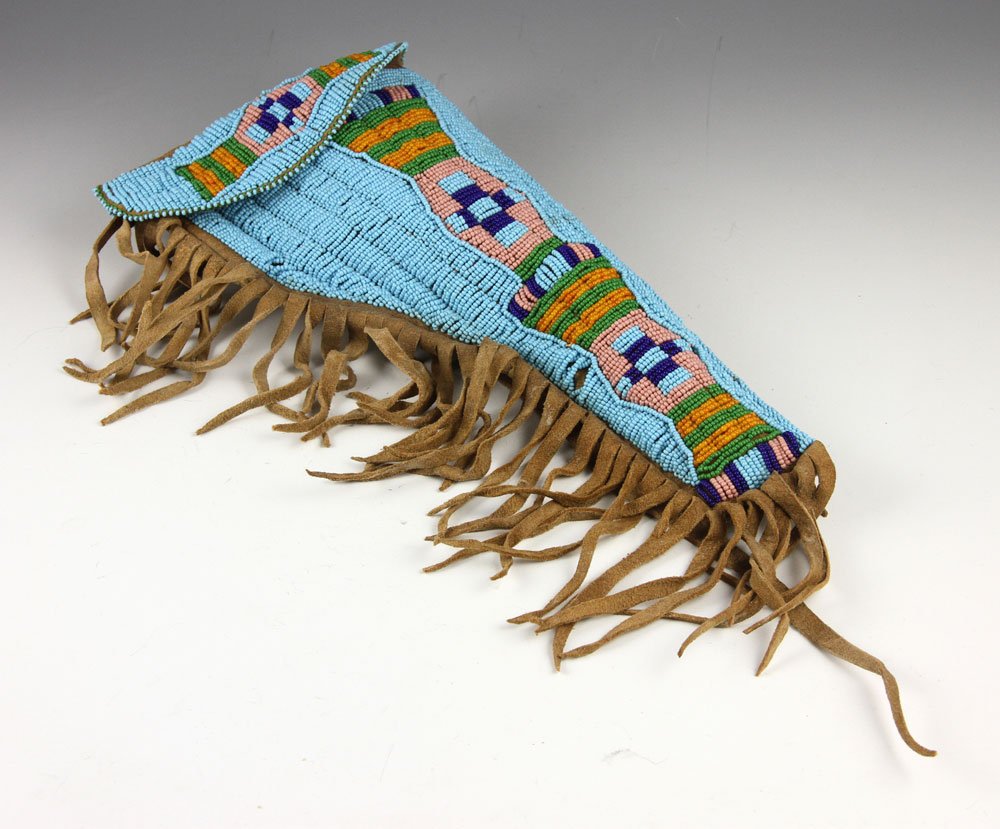 Montana Crow Beaded Snake Pattern Holster: Montana Crow beaded snake pattern holster, of the Crow Native American tribe, glass bead decoration on tanned hide, 11 1/2" h x 5 1/2" w excluding fringe. Provenance: From an Arizona estate.