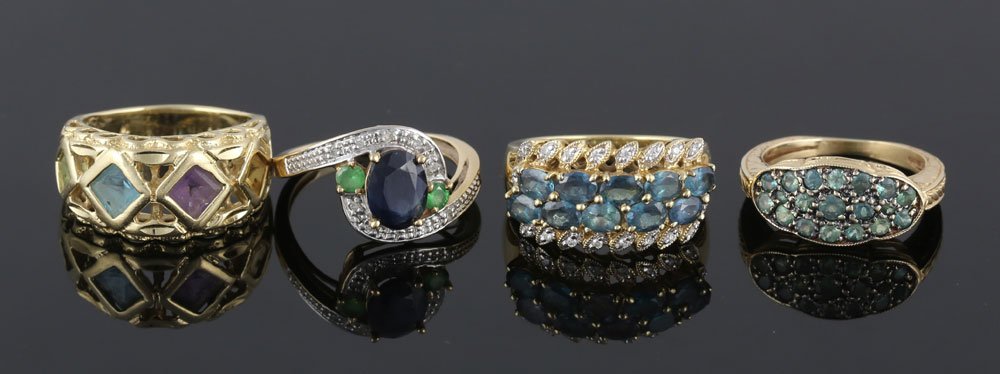 Collection of Four 14K Gold Rings: Collection of four rings, 14K yellow gold and colored stone, two having diamonds, approximately 18 grams total weight. Provenance: from a Massachusetts estate.