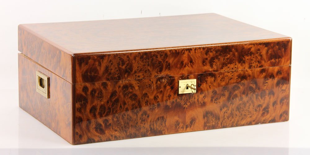 Davidoff Burl Wood Cigar Humidor: Cigar humidor, burl wood veneer with brass accents, marked "Made by hand in Switzerland" and "Davidoff," with Davidoff cigar cutter, 7 3/8" h x 19 1/2" w x 13 5/8" d. Provenance: from an Arizona estat