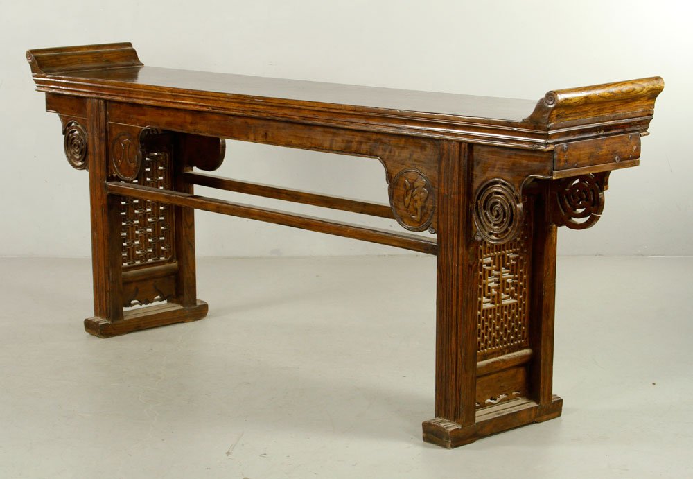Chinese Altar Table: Late 19th century Chinese altar table, Chai wood, carved legs, with Chinese character on skirt, 38 1/2" h x 97" w x 17 1/2" d. Provenance: From the collection of interior designer Thomas Britt.
