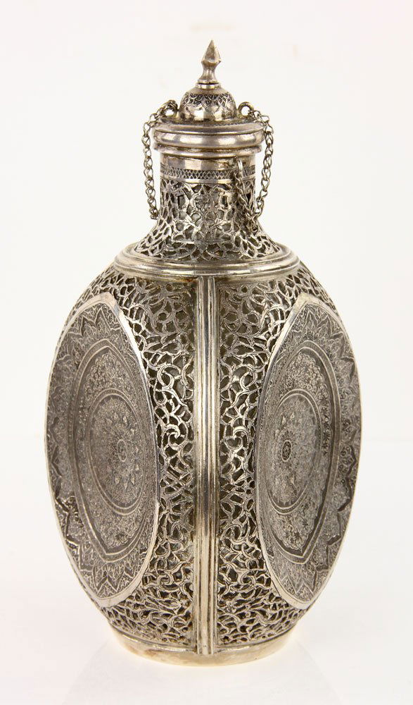 Islamic Silver Flask: Islamic flask, sterling silver, with cork top, having exquisite repousse over glass, three panels, hallmarked "Vartan," "84," and Arabic letters, 9 1/2" h x 5 1/4" w. Provenance: from the lifelong col