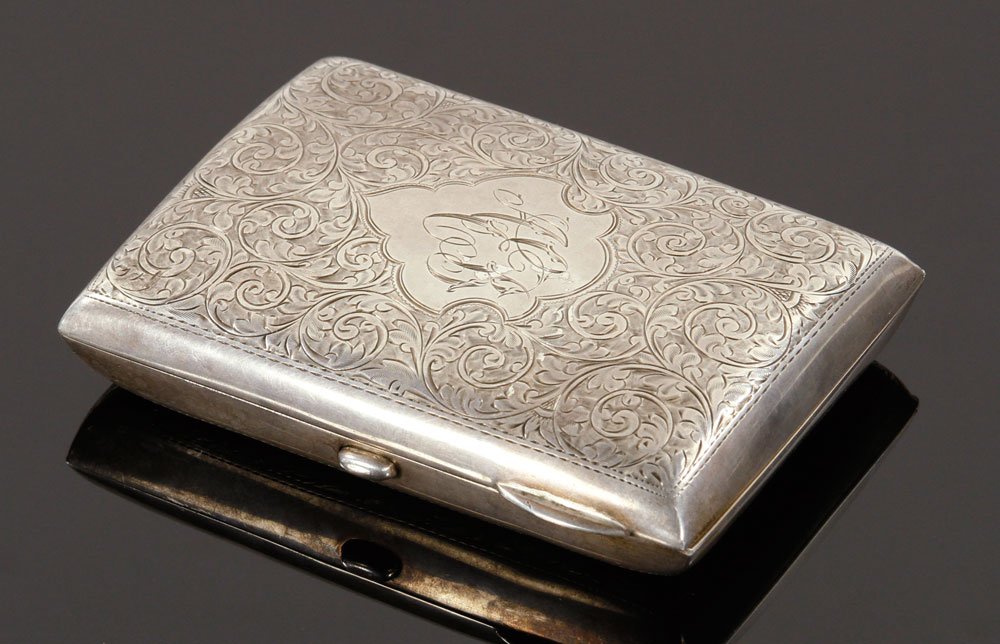 English Sterling Cigar Case: English cigar case, sterling silver, having chased scenes, hallmarked for Birmingham, England circa 1938-1939, 5" h x 3 1/2" w, approximately 6.1 troy oz total weight. Provenance: from the lifelong co