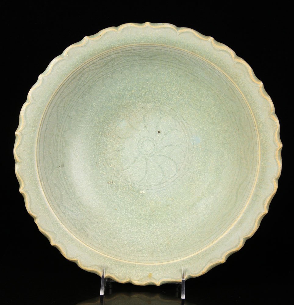 Ming Dynasty Royal Nanhai Celadon Bowl: 15th century Ming Dynasty bowl, celadon glazed porcelain, recovered from the Royal Nanhai cargo shipwreck and having sticker on base, with scalloped edge, 3 1/2" h x 12" dia. Provenance: from the life