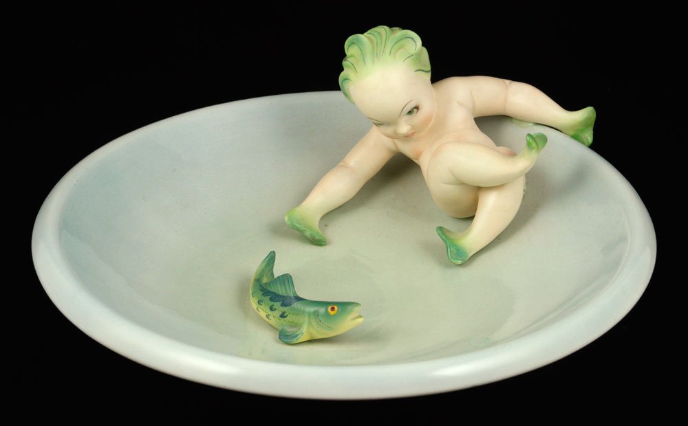 Lenci "Piccolo Tritone" Figure: Lenci "Piccolo Tritone" figure, porcelain, depicting a small Triton with fish, designed by Camillo Ghigo, 4 3/4" h x 12 5/8" dia. Provenance: from the lifelong collection of a Kansas City, Missouri fa