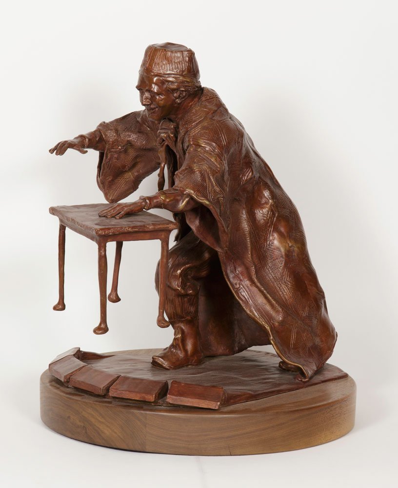Bull, Marco the Magi Floating a Table, Bronze: David F. Bull, Marco the Magi (Cesareo R. Pelaez) floating a table, bronze, signed "D. Bull 1997", "TALIX" foundry mark, one of three editions, on wooden base, 18"h x 15"dia (including base). Provenan