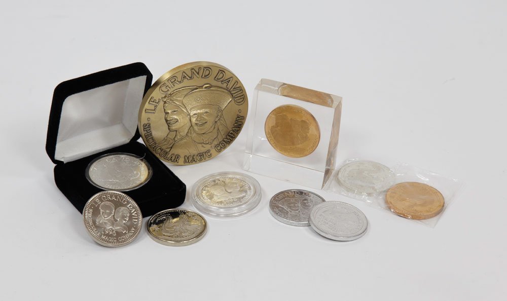 Complete Set of 9 Le Grand David Coins and Medallion: Complete set of nine Le Grand David coins (1 1/2" dia) and bronze medallion (3" dia), to include: three made of .999 silver, 25th anniversary coin, 20th anniversary coin, early Marco, David & Seth coi