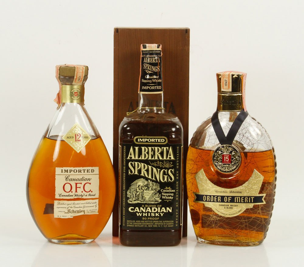 3 Bottles Vintage Canadian Whiskeys: Three bottles of vintage Canadian whiskeys, circa 1950s to 1970s, to include: Alberta Springs, 1973, low shoulder; Canadian OFC, low shoulder (Schenley); and Order of Merit Schenley, 1947, below shoul