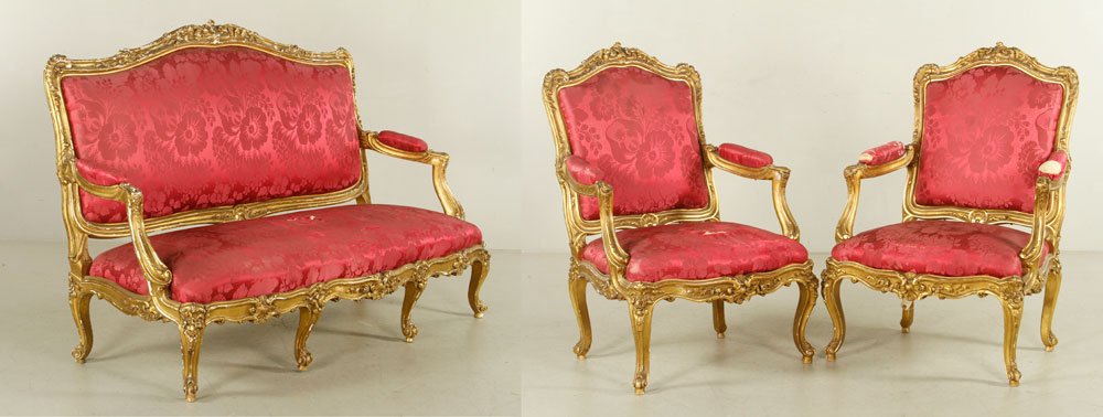 Louis XV Style Parlor Suite: Louis XV-style parlor suite, 19th century, with red satin upholstery, to include one couch and two armchairs, largest measuring 46" h x 70" w x 34" d. Provenance: From a Massachusetts estate.