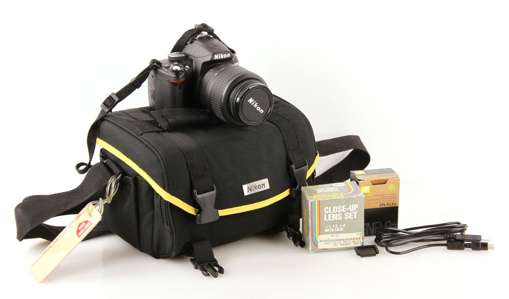 Nikon Camera with Case: Nikon D3000 camera in case, with Nikkor 18-55 mm lens. Provenance: From the estate of John Rosenfield, a Harvard professor and art historian with a specialization in Japanese art.