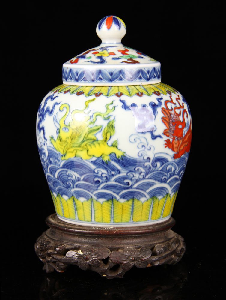 Chinese Dou-Cai Mythical Beast Jar: The jar is brilliantly enameled in fifteenth-century style with mythical ocean beasts around the exterior above lotus blooms growing from base, all enameled above under-glaze cobalt blue, with origina