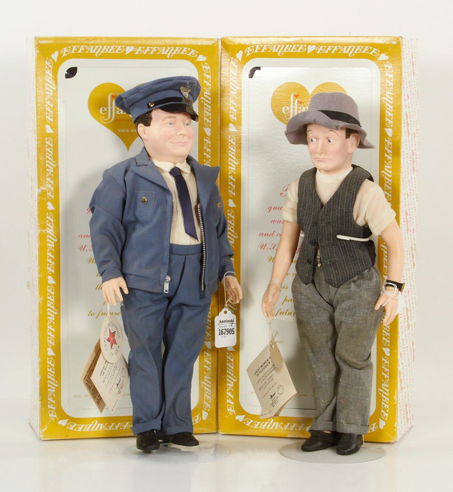 Two Effanbee Honeymooners Dolls: Two Effanbee Honeymooners dolls, Ralph Kramden played by Jackie Gleason and "Ed" Norton played by Art Carney, in original outfits, with original tags and boxes, with stands, Ralph is 16" h. Provenance