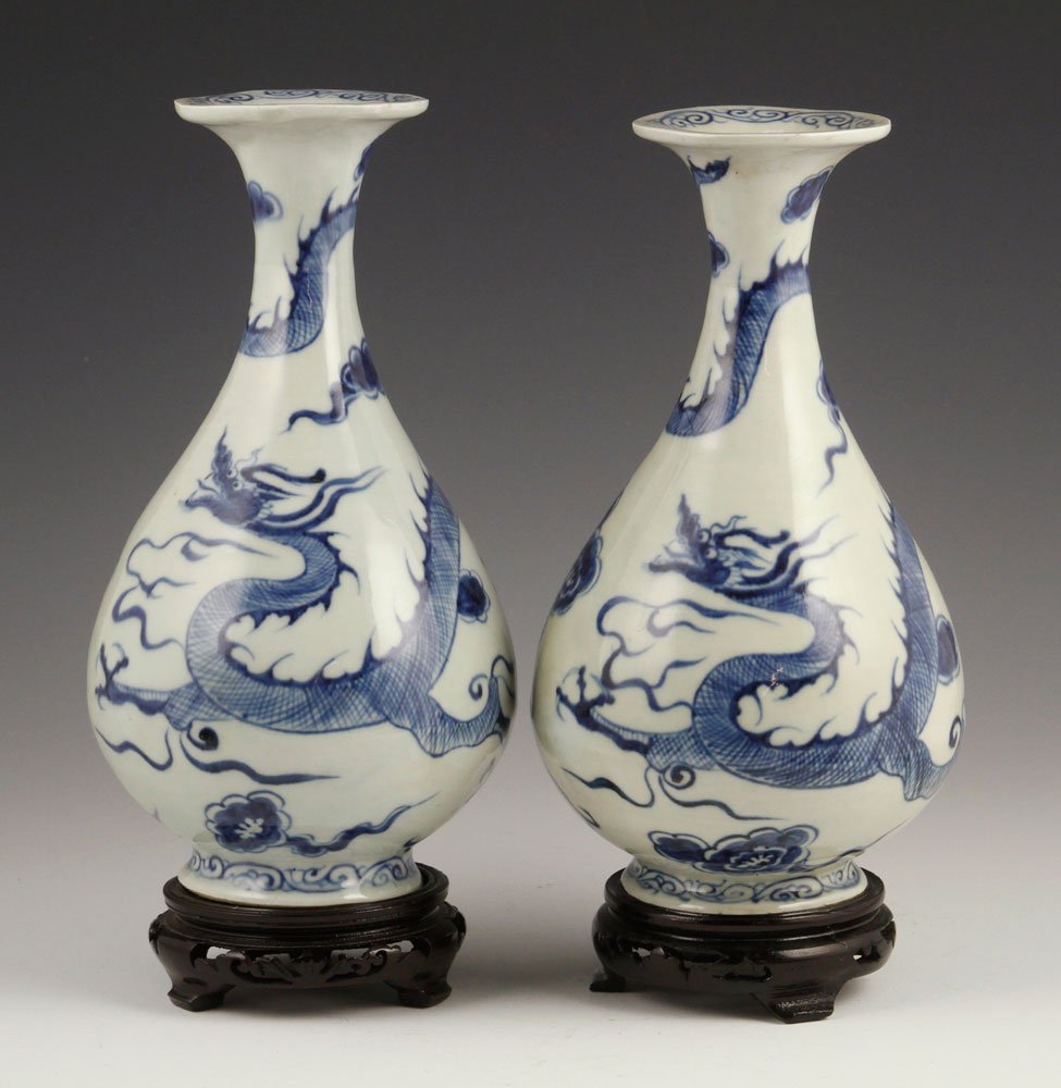 Pr. Chinese Dragon "Yuhuchun" Vases: The blue and white pear-shaped vases each painted with ferocious Mongolian dragons amongst cloud, with biscuit base, 9 1/4" h. Provenance: From a Texas collection.