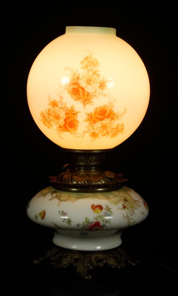 Gone with the Wind Lamp: Gone with the Wind lamp, decorated with floral motif, 19 1/2" h (overall), 9" dia (shade). Provenance: From a New Hampshire estate.