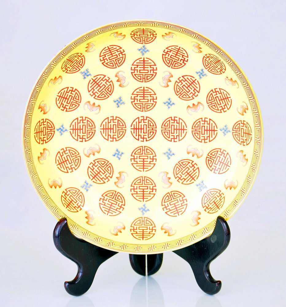 Chinese Famille Shou Charger: Enameled longevity, bat and Buddhist marks in symmetric pattern, with further lotus paint around exterior, iron-red mark on base with original stand, 13 1/2" dia. Provenance: from a Massachusetts esta