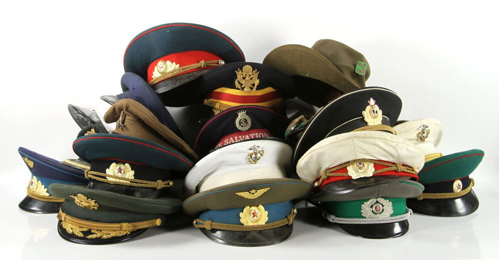 Lot of Military Hats: Lot of eighteen military hats, to include Russian, American, and British. Provenance: From the estate of film, television and stage performer Raymond Kyle-Koscuik. Originally from New York, Kyle settl