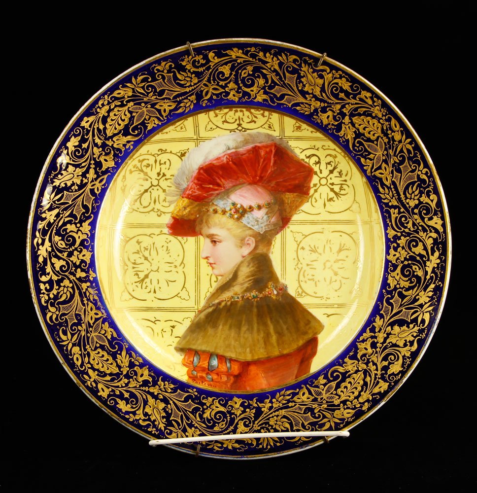 French Sevres Portrait Plate: French Sevres plate, decorated with a portrait of a lady wearing a red hat, with gilt accents, circa 1900, 11 1/2" dia. Provenance: From the collection of Gilbert Pelham, former Manhattan antiques dea
