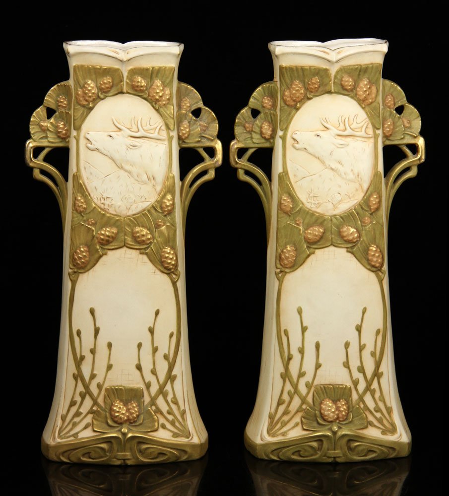 Pr. Royal Dux Vases: Pair of Royal Dux vases, decorated with moose and pine cone details, 16" h x 13" w x 3 1/2" d. Provenance: From the personal lifetime collection of Mark Avner of Lake Worth, FL and Buffalo, NY.