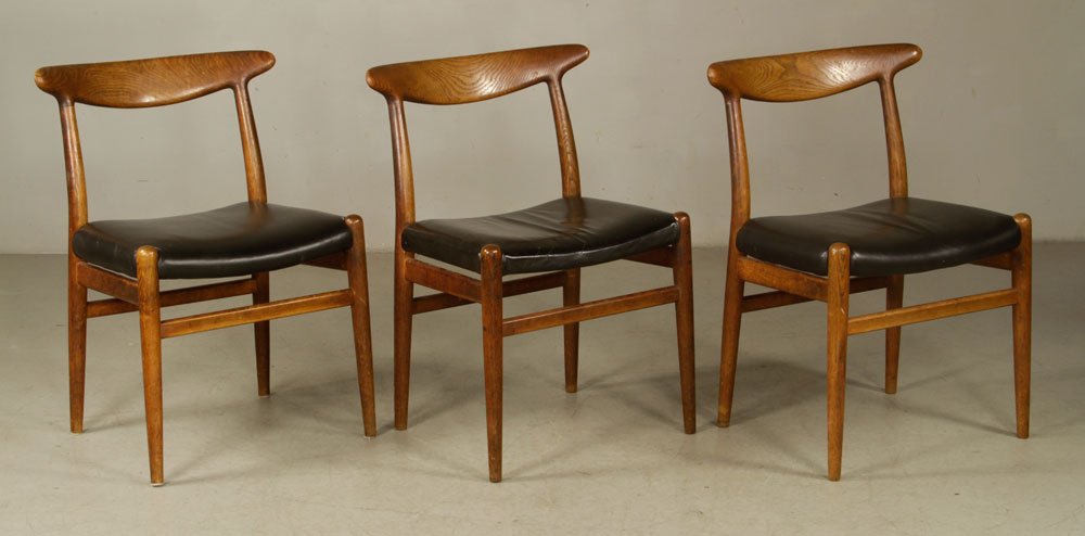 Three Hans Wegner Elbow Chairs: Hans Wegner (Danish, 1914-2007), set of three Elbow chairs, signed "C. M. Madsens" and "Design Hans J. Wegner," 29 1/2" h x 21 1/2" w x 16" d. Provenance: From a Massachusetts estate.