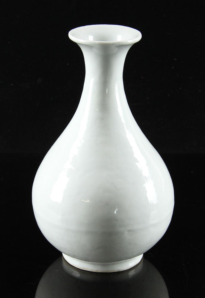 Chinese White Glazed Yuhuchun Vase: Chinese white glazed Yuhuchun vase, 20th century, porcelain, impressed with delicate dragon and phoenix designs under glaze, having blue Ming Jiajing mark on base, 9 1/4" h. Provenance: from a Texas e