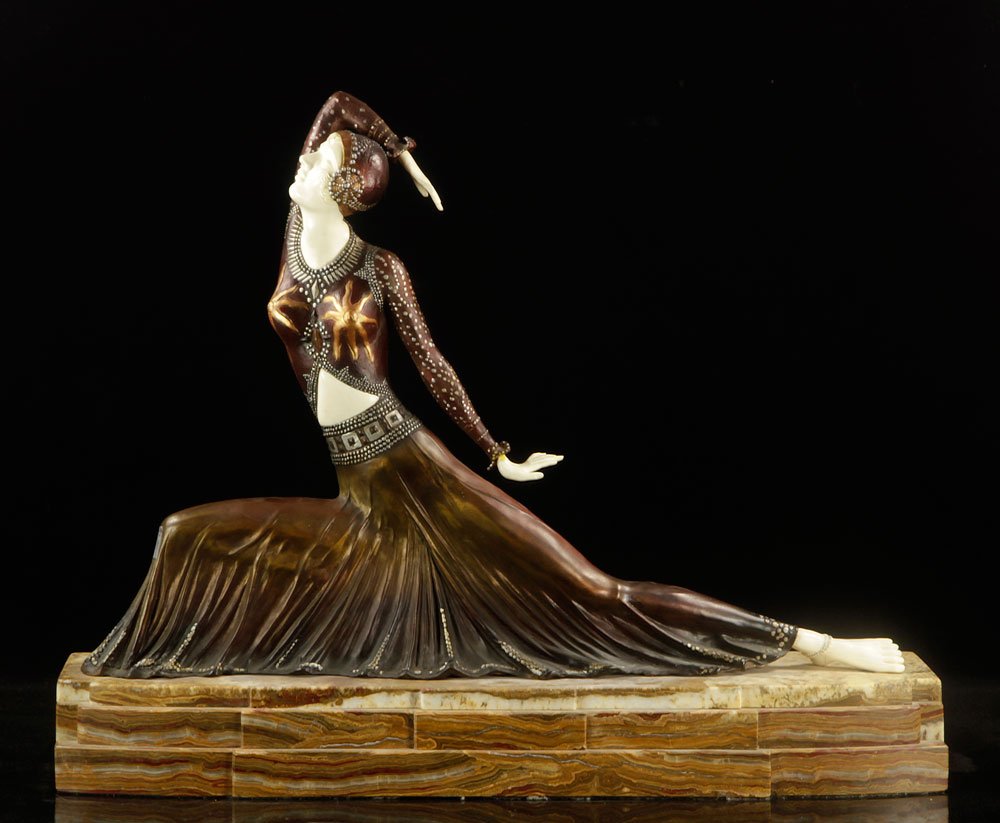After Chiparus, "The Deco Dancer," Bronze and Bone: After Demetre Chiparus (Romanian, 1886–1947), "The Deco Dancer," bronze with carved walrus bone hands and face, on marble plinth, 24" h x 30" w x 8" d. Provenance: from a California estate.