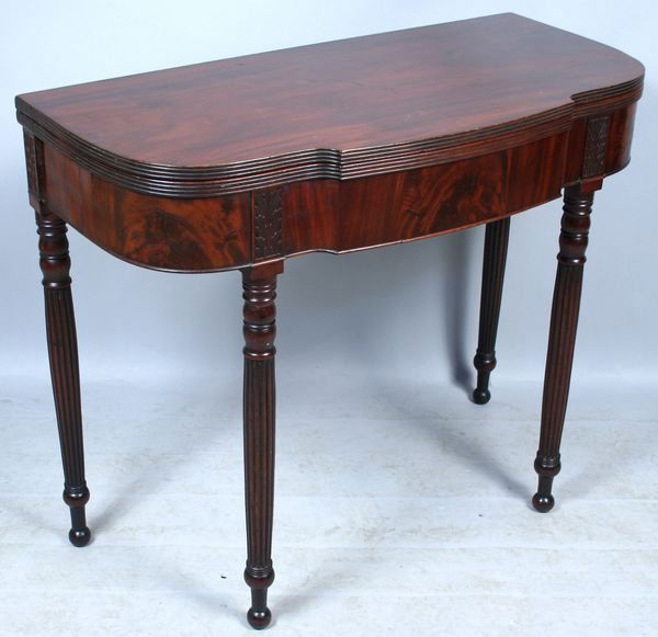 PHILADELPHIA SHERATON MAHOGANY CARD TABLE: Antique Philadelphia Sheraton mahogany card table with carved capitals above reeded legs, 29 3/4"h. x 36"w. x 17"d., inscribed on rear of table 'Major Reinvehl's Table'. Some scratches to top, some mi