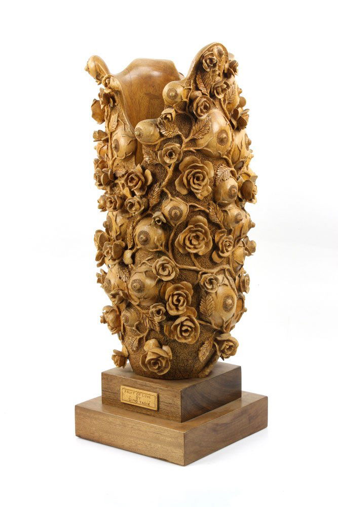 "Fruit of Love" Elaborately Carved Decorative Vase: "Fruit of Love" sculptural vase, intricately carved wood with blossoms and breasts, signed "Simo Todic," 25 1/2" high. Provenance: from the personal collection of Larry and Joy Redman of Lompoc, Calif
