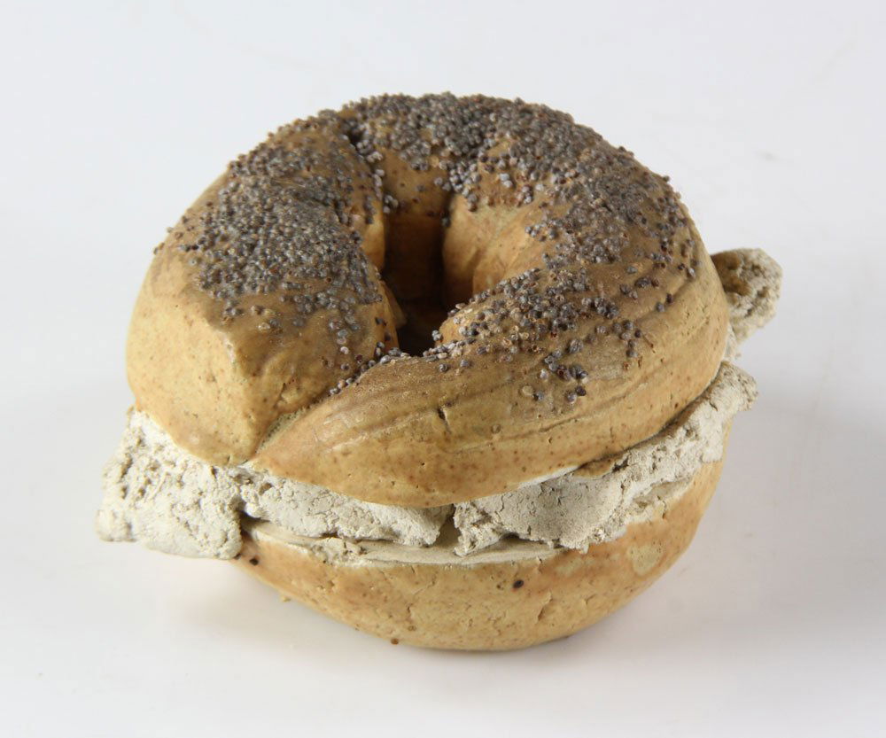Gilhooly, Poppy Seed Bagel, Ceramic: David James Gilhooly (American, 1943-2013), poppy seed bagel with cream cheese, ceramic, signed and dated underneath, 4 1/4" high x 2" wide. Provenance: from a Los Angeles, California estate.
