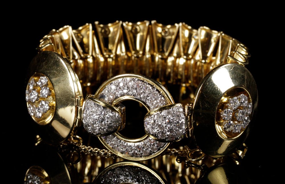 Ladies' 18K Gold and Diamond Bracelet: Ladies' 18K gold and diamond bracelet, signed "Van Cleef," measuring 6 5/8" l x 1" w, approximately 83 grams TW; no GIA report available, color, cut and clarity unknown. Provenance: From a New York co