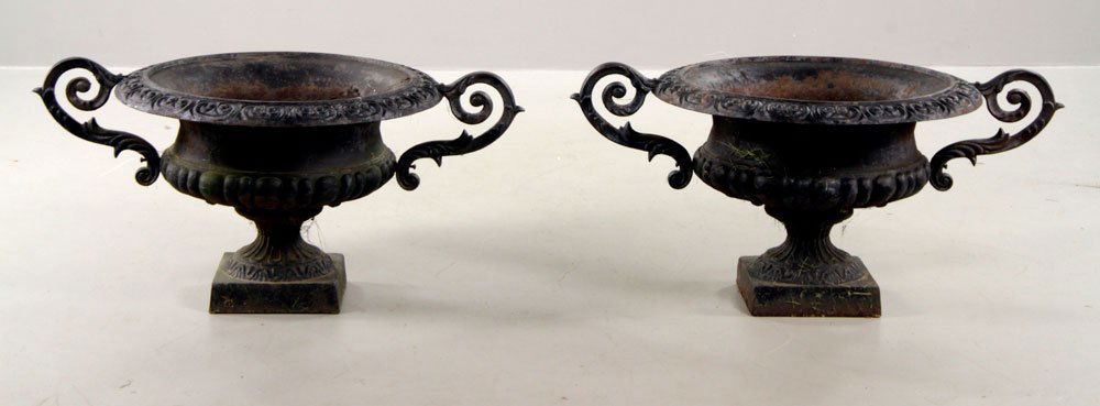 Pr. Cast Iron Urns: Pair of cast iron urns, with handles, 17 1/4" h x 36" w (including handles).
